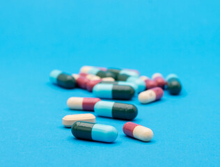 green capsule pill on blue background table medicine vitamin antibiotic and medical treatment of hospital and clinic