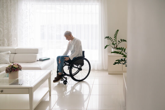 Woman In Wheelchair At Bright Luminous Home