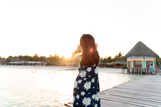Little girl by the sea at sunrise, Mexico