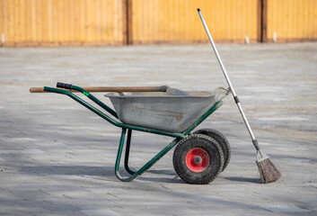 Wheelbarrow for collecting garbage on the street.