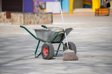 Wheelbarrow for collecting garbage on the street.