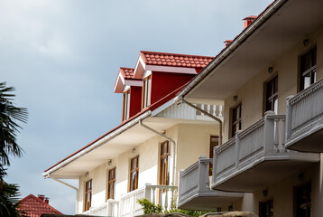 Roofs of houses with dormer windows against the sky. Urban architecture.