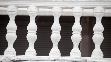 Row of white concrete balusters on the embankment close-up