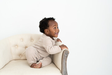Baby looking to the side in a chair