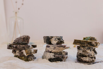 Stacks of flat crystal stones with lavender in the background