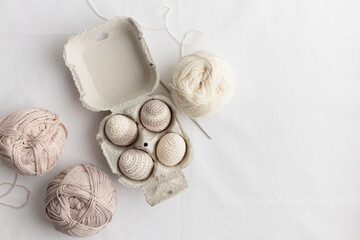 Set of cute easter crocheted eggs, pastel color in the eggbox