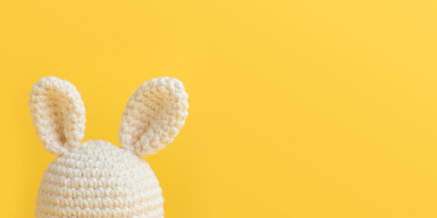 Easter crochet bunny white ears on yellow background