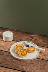 cottage cheese pancakes, cream in a saucepan