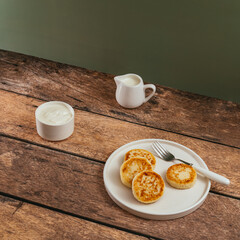 cottage cheese pancakes, cream in a saucepan