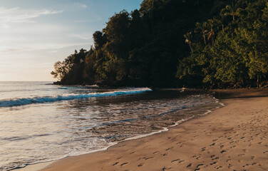 Waves rolling in on a warm sandy beach in Costa Rica.