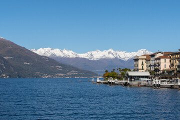 Naklejka premium scenic view of the port of menaggio with the snowy mountains