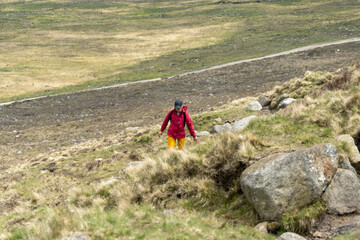 Hiker woman climbing a mountain
