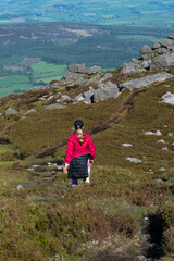 Fototapeta na wymiar woman hiker going down small hill