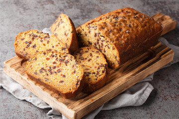 Chocolate chips pumpkin cake sliced on board closeup on the table. Horizontal