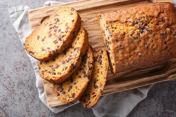 Fresh Homemade Chocolate Chip Pumpkin Bread ready to eat closeup on the wooden board on the table. Horizontal top view from above