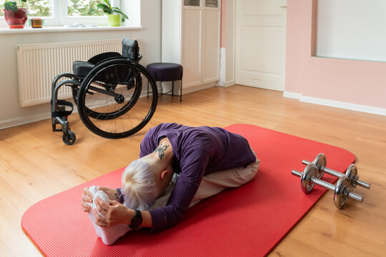 Person With Disability Stretching On Mat