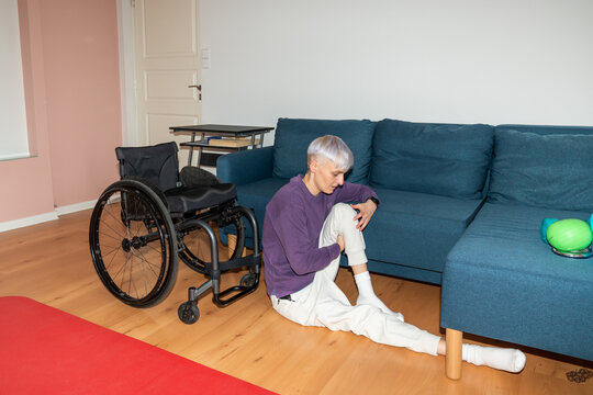 Woman Preparing To Sit On Wheelchair