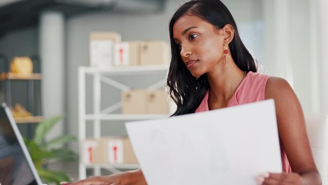 Laptop, paper and fashion designer woman with startup business, retail logistics and online shop planning and decision. Serious indian person analysis, choice and sketch check, ecommerce and computer