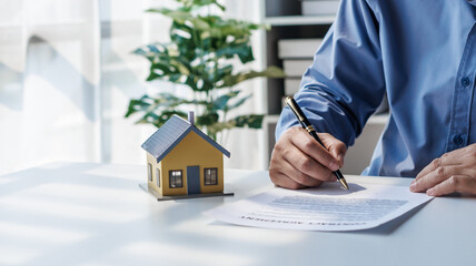 real estate agent Hand over the keys and the model house to the customer and the home insurance contract. home mortgage loan concept