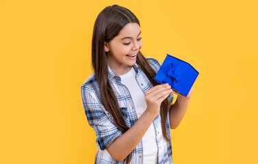 curious teen girl with birthday gift on background. photo of teen girl with birthday gift box.