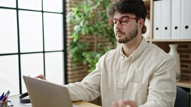Young hispanic man business worker doing yoga exercise at office