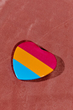 heart-shaped badge with the pansexual flag
