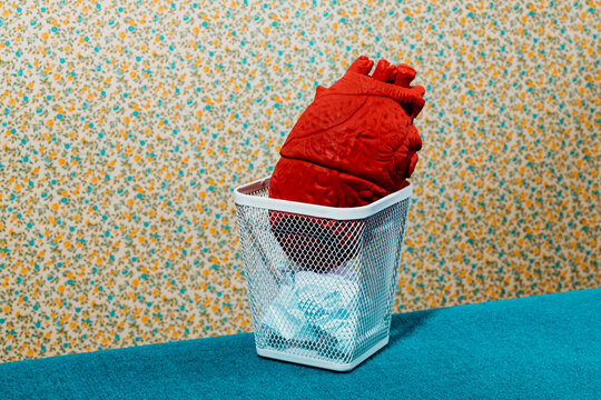 fake human heart in a trash can