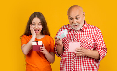 shocked kid and granddad with present box for anniversary