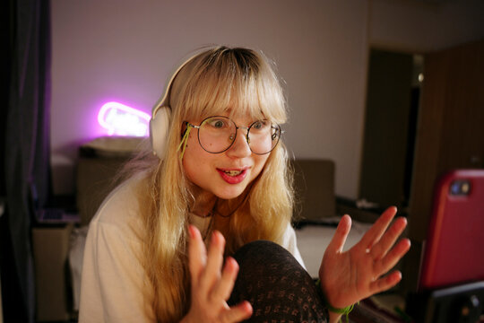 Teen girl using smartphone at night