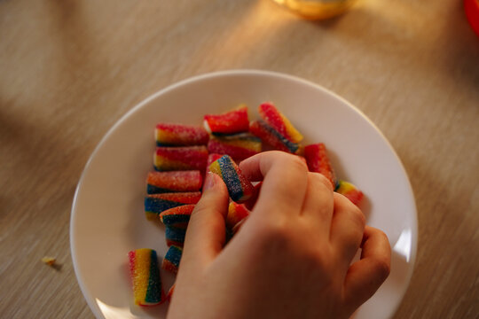 The hand reaches for sweets