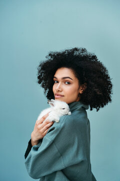 Mixed-race female portrait with rabbit.