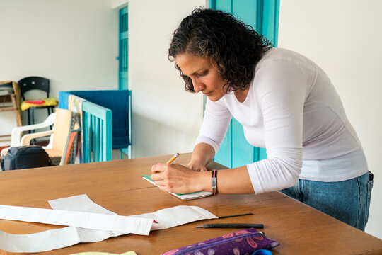 Designer crouched over a table drawing