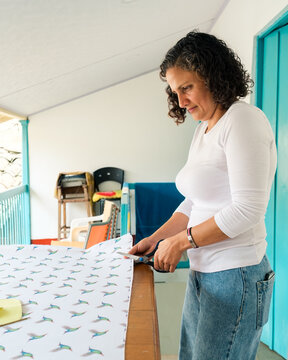 Dressmaker cutting a canvas with scissors