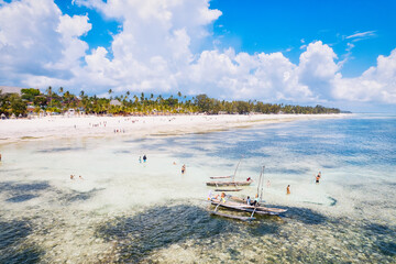 Fototapeta na wymiar The white sandy beaches of Zanzibar are the ideal spot for spending lazy Zanzibar beach summers.