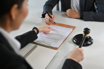 Cropped shot of lawyer giving consultation and negotiating a contract with client. Law services concept.