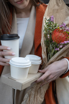 Close-up of Woman Holding Coffee and Flowers 