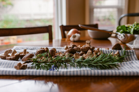 Rosemary and mushrooms to prepare recipe tabletop