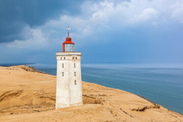 Fototapeta na wymiar Seascape view at Rubjerg knude lighthouse at sand dunes