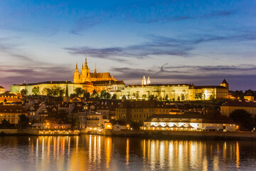 Fototapeta na wymiar Night view over the river Moldau and the castle during blue hour in Prague, Czech Republic