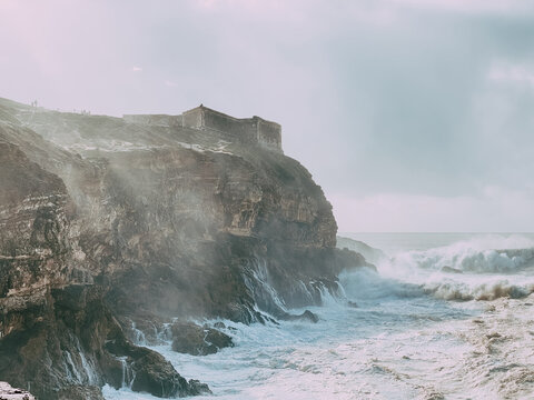 Huge waves crushing near cliffs in Nazare, Porugal