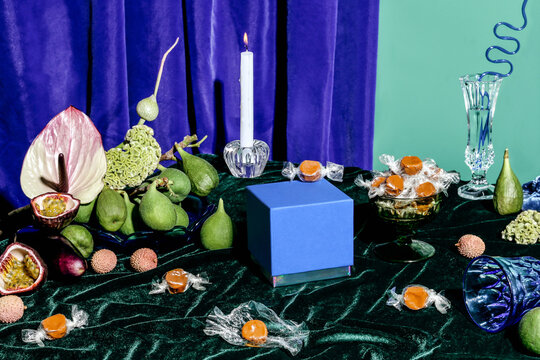 Scene with candies, candle, and flowers