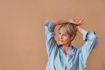 Portrait of beautiful female with pink ribbon.