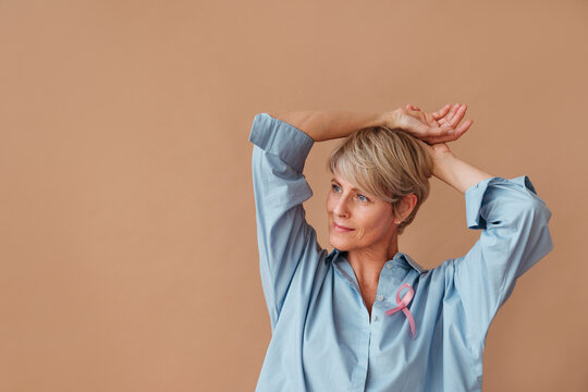 Portrait of beautiful female with pink ribbon.