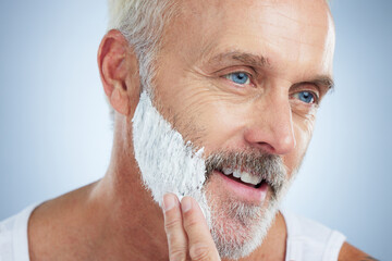 Mature man, face and shaving cream for grooming, skincare or hair removal against studio...