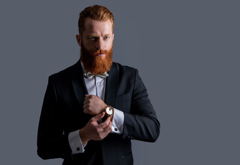 man wearing elegant wrist watch and tuxedo, copy space. tuxedo fashion. handsome bearded man