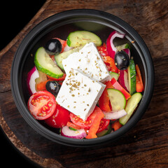 Fresh Greek salad with pepper, tomato, olive, feta cheese, cucumber, lettuce, oil. To Go Salad