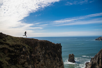 free woman runner running on the cliff. freedom and motivation