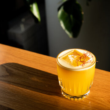Saffron Grapefruit Fizz coctail, lit by the sun
