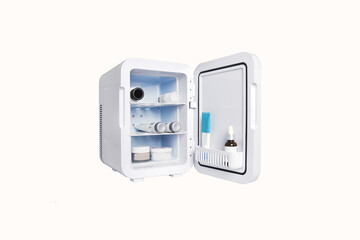 Isolated small cosmetic refrigerator on a white background,open for men and women skin care...