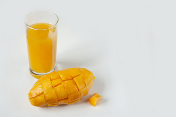 mango juice and fruit on a white background, copy space